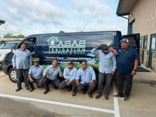 The Casas Irrigation Drainage & More team standing in front of their branded service van in Frisco, TX