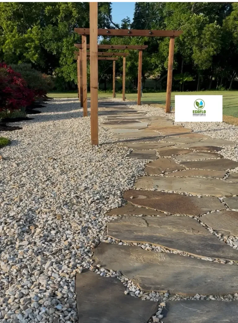 Flagstone walkway bordered by white gravel leading through a series of wooden arbor arches